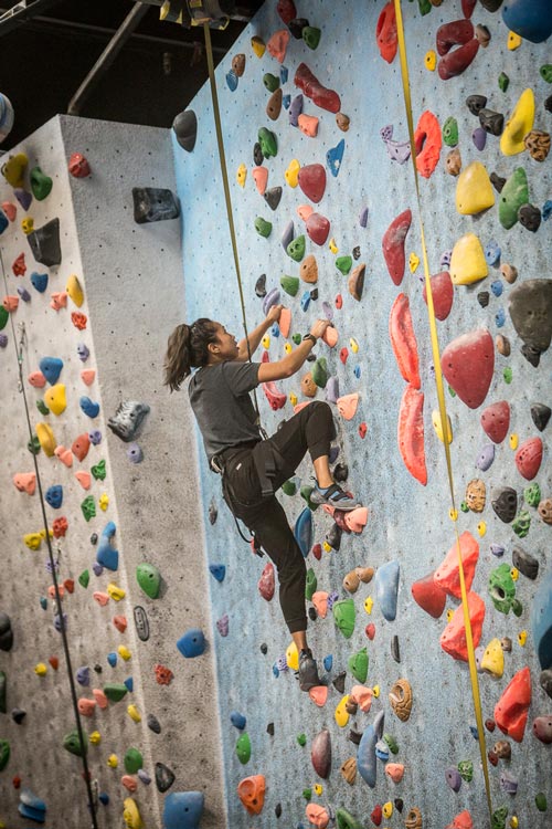 young climber ascends wall at focus climbing center